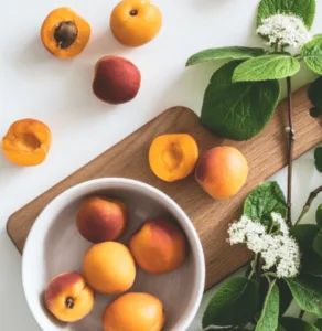 Arrangement of peaches on a table.